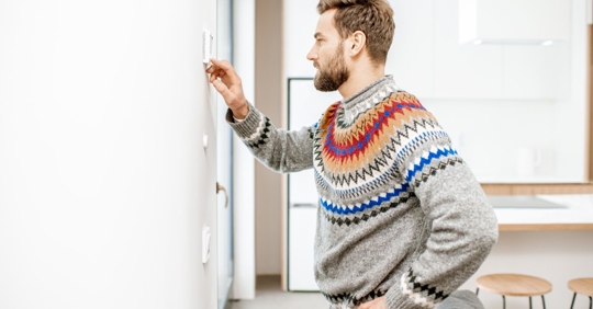 man cold adjusting thermostat